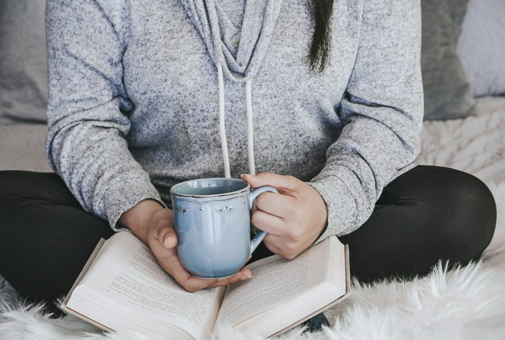 A warm mug held over an open book